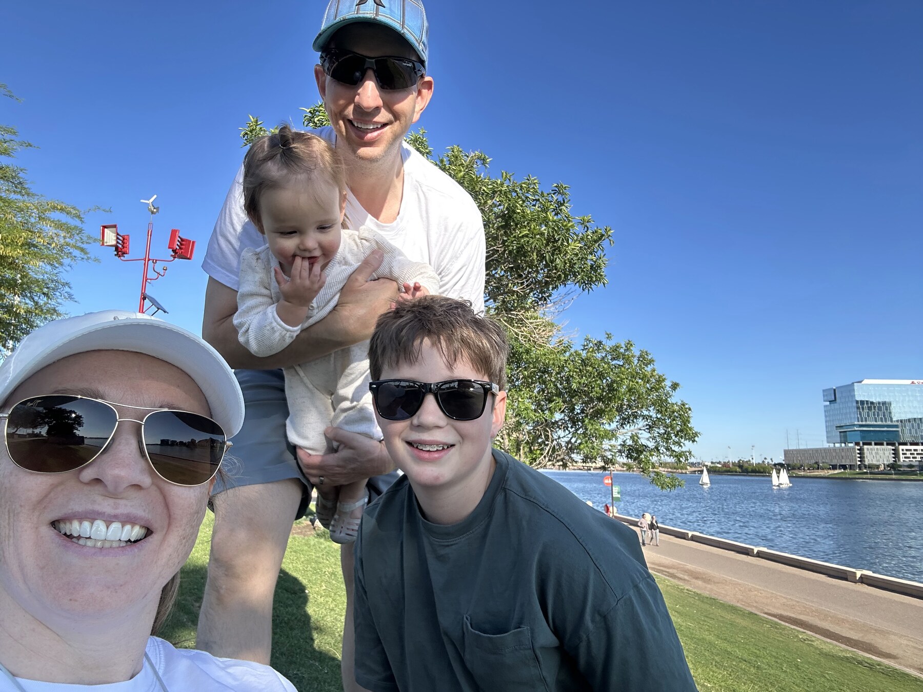 Doug and family at Tempe Town Lake with sailboats in the background